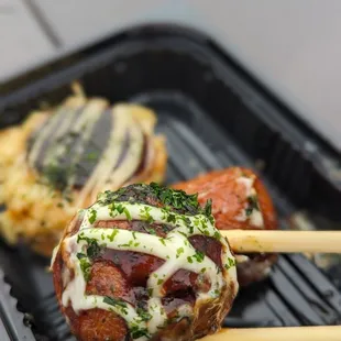 two meatballs on a grill
