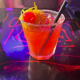 a bloody cocktail with a cherry garnish