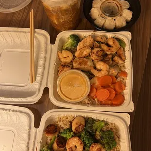 a variety of food items including rice, shrimp, broccoli, and carrots