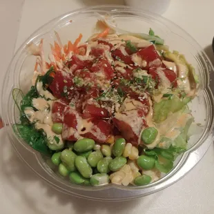 11/3 Spicy Tuna Poké Bowl. Edamame, corn, avocado slices, carrots, cucumber, seaweed salad, salad, rice, mayo sauce, and sesame seeds.