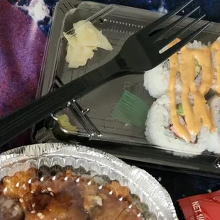 a tray of sushi and a container of rice