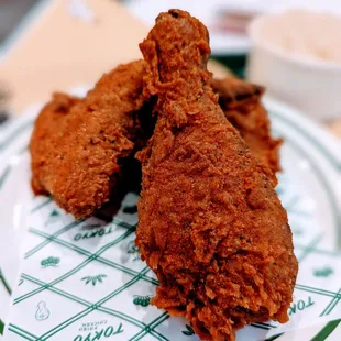 two pieces of fried chicken on a plate