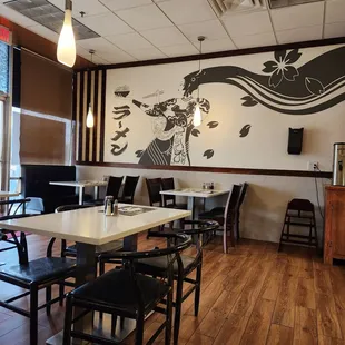a dining area with tables and chairs