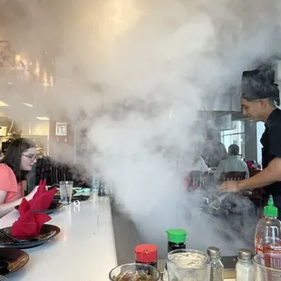 smoke billowing from a restaurant counter