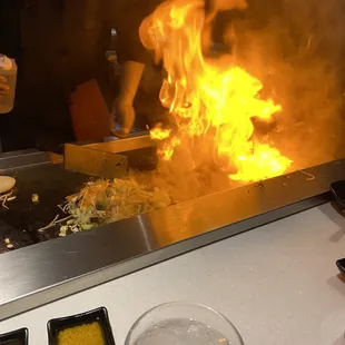 a man cooking food on a grill