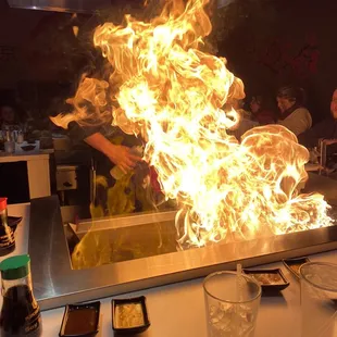 a person cooking food on a large grill