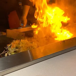 a person cooking food on a grill