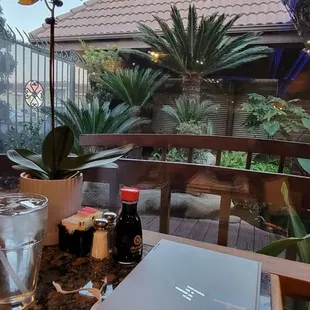 a table with a laptop and glasses on it