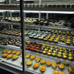 Dessert case with cakes and fruit