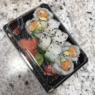 a sushi dish in a plastic container