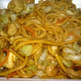 a plate of noodles with meat and vegetables