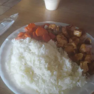 a plate of rice, carrots, and tofu