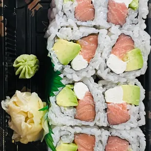 a tray of sushi and avocado