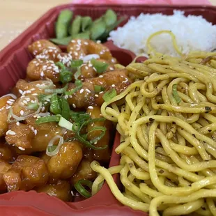 a plate of noodles, meat and vegetables