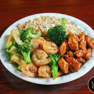 a plate of shrimp, broccoli, and rice