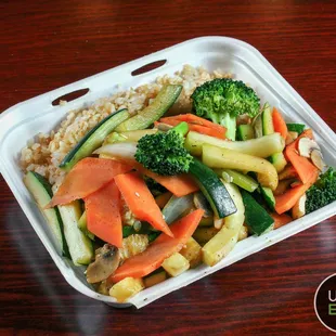 a takeout container of vegetables and rice