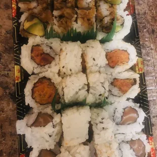 a plate of sushi and rolls