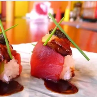 two sushi rolls on a plate