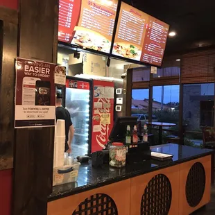 the counter and menus of a fast food restaurant