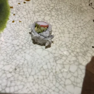 This is a solitary piece of California roll.