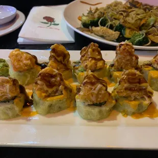 COWBOY ROLL . It's fried, Not spicy, the top part is crab salad and no it doesn't have a seafood taste.