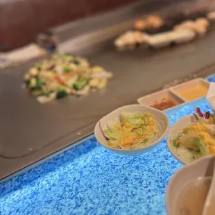 plates of food being prepared at a buffet
