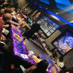 a group of people sitting at a long table