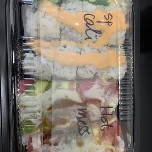 a close up of a container of sushi