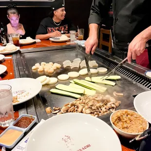 a chef preparing food on a grill