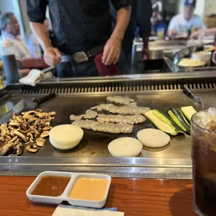 a man preparing food on a grill