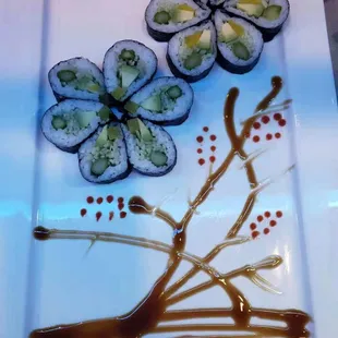 a plate of sushi and sauce