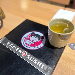 a cup of tea and a menu