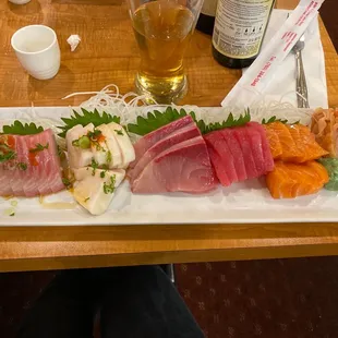 a plate of sushi and a glass of beer