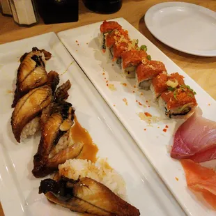 a plate of sushi and rolls