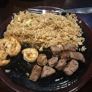 a plate of rice, meat, and shrimp