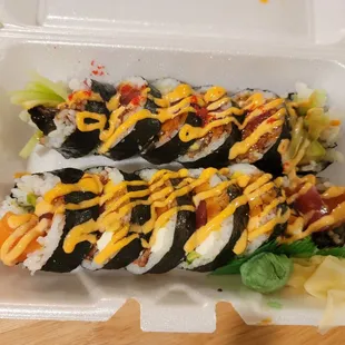 sushi rolls in a styrofoam container