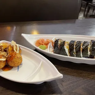 two plates of sushi and rolls
