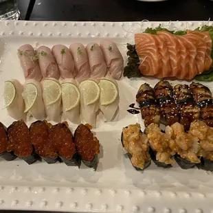 Hamachi nigiri, salmon sashimi, escolar nigiri, eel nigiri, ikura nigiri, and chopped spicy scallop nigiri