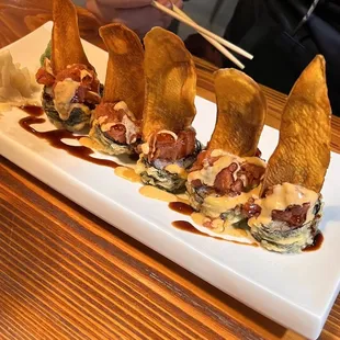 a plate of appetizers with chopsticks