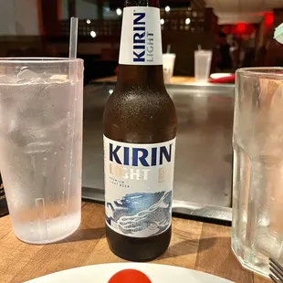 a bottle of kirin beer and a glass of water