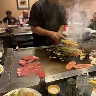 a man cooking on a grill