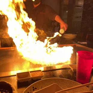 a man cooking on a grill