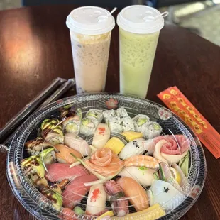 a plate of sushi and a drink