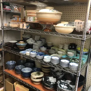 a shelf full of dishes and bowls