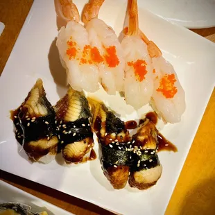 a plate of sushi and shrimp