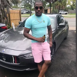 a man standing in front of a car
