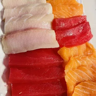 a plate of sashi and lime slices