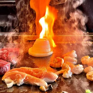 a person cooking food on a grill