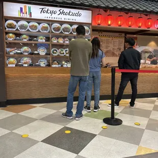 people standing in front of a restaurant