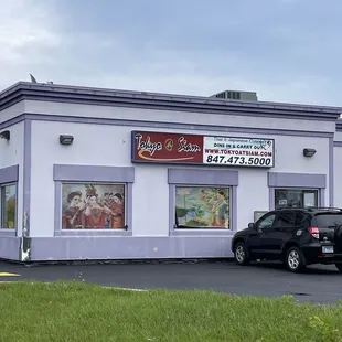 a car parked in front of a restaurant